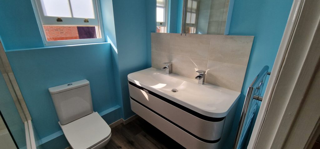 Modern bathroom refurbishment with vanity and shower bath in Wimbledon London