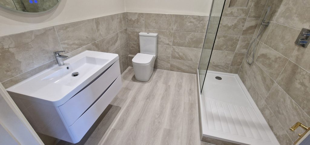 Modern bathroom refurbishment with walk-in shower, wall tiles and vanity unit installed by Sublime Property in London Surrey Sussex