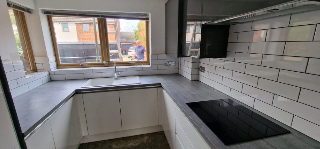 Modern kitchen installation with worktop, sink and subway tile backsplash in London