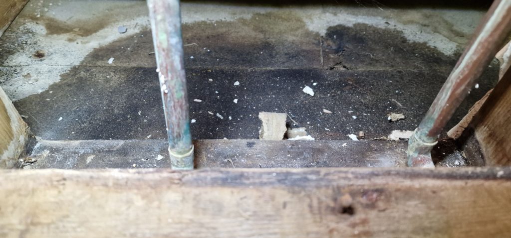 Water leak detection showing damaged bathroom floor and exposed plumbing during leak investigation in London